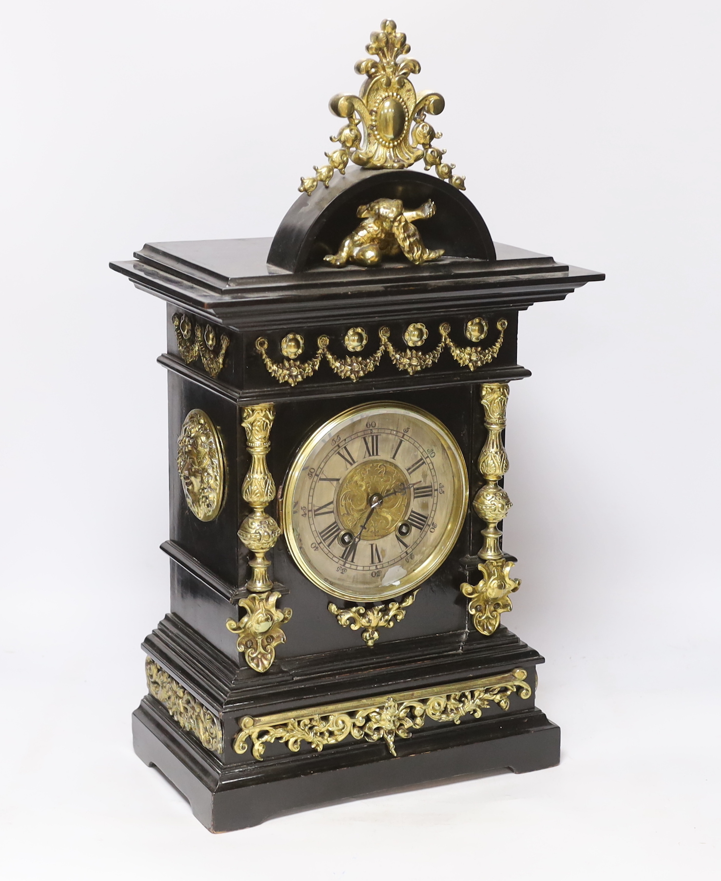 An ebonised German bracket clock with brass decoration, with a Lenzkirch movement striking on a coiled gong, 53cm high, with bracket